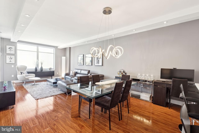 dining space featuring a chandelier, wood finished floors, and recessed lighting