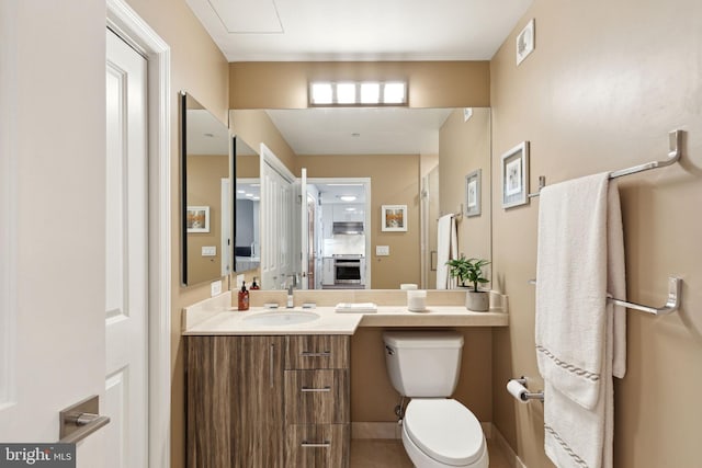 bathroom with toilet, visible vents, and vanity