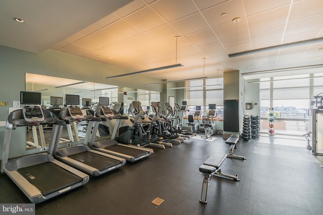 exercise room featuring floor to ceiling windows