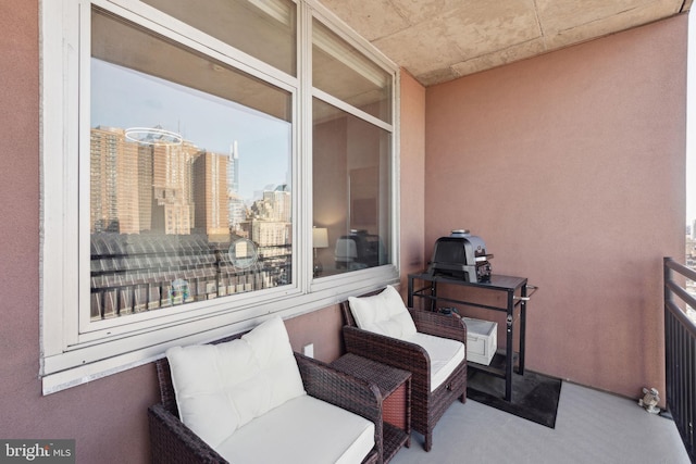 view of patio / terrace featuring a view of city and a balcony