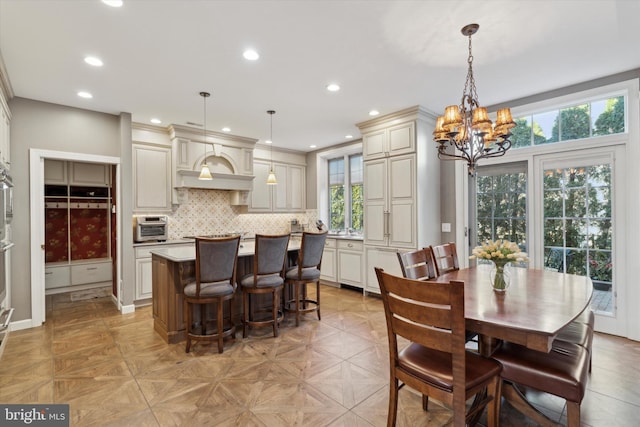 dining room featuring a chandelier and recessed lighting