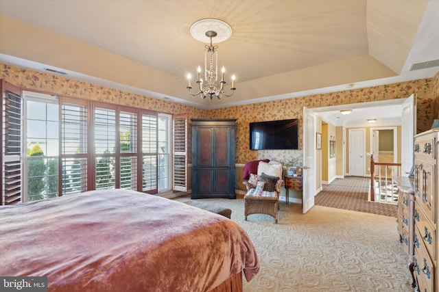 bedroom with wallpapered walls, visible vents, and a tray ceiling