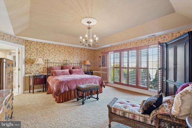 carpeted bedroom featuring a notable chandelier, a raised ceiling, visible vents, and wallpapered walls