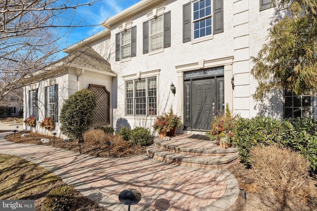 property entrance featuring stucco siding