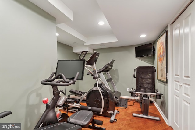 workout room featuring recessed lighting, wood finished floors, and baseboards