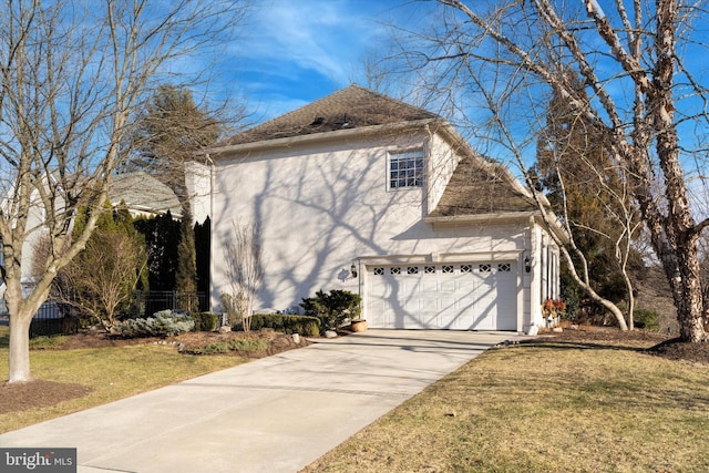 view of property exterior featuring a garage, a yard, driveway, and stucco siding