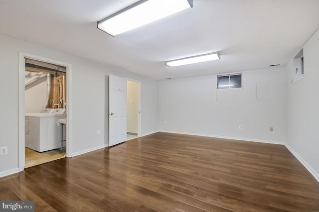 interior space with baseboards, visible vents, washing machine and clothes dryer, and wood finished floors