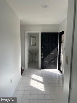 interior space featuring baseboards and light tile patterned floors