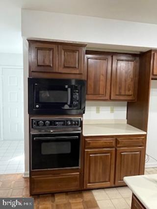 kitchen with light countertops and black appliances