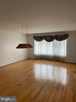 spare room with wood finished floors