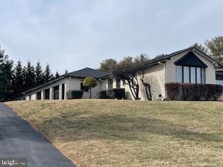 view of side of home with a garage and a yard