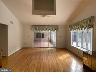 unfurnished living room with lofted ceiling and wood finished floors