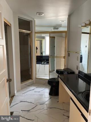 bathroom featuring marble finish floor and toilet