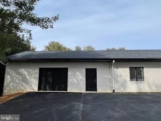 view of side of home featuring an attached garage