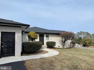 view of front of property with a garage and a front lawn