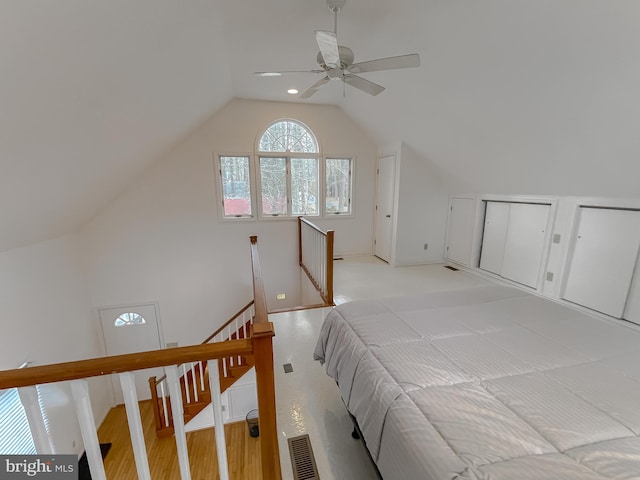 bedroom with a ceiling fan, lofted ceiling, and visible vents