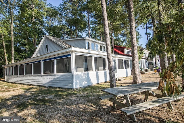 view of home's exterior with a sunroom