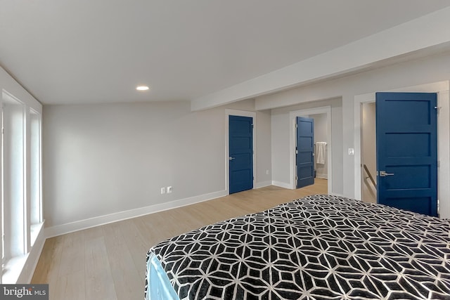 bedroom featuring recessed lighting, ensuite bath, light wood-style flooring, and baseboards