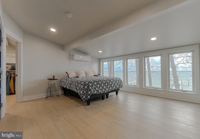 bedroom featuring recessed lighting, a wall mounted air conditioner, baseboards, and wood finished floors