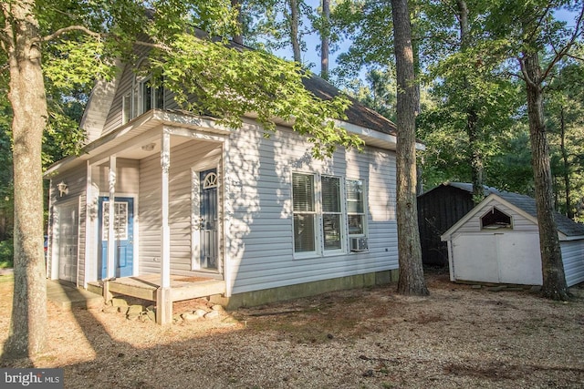 exterior space with cooling unit, an outdoor structure, and a storage shed