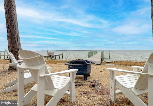 view of yard featuring a water view and an outdoor fire pit