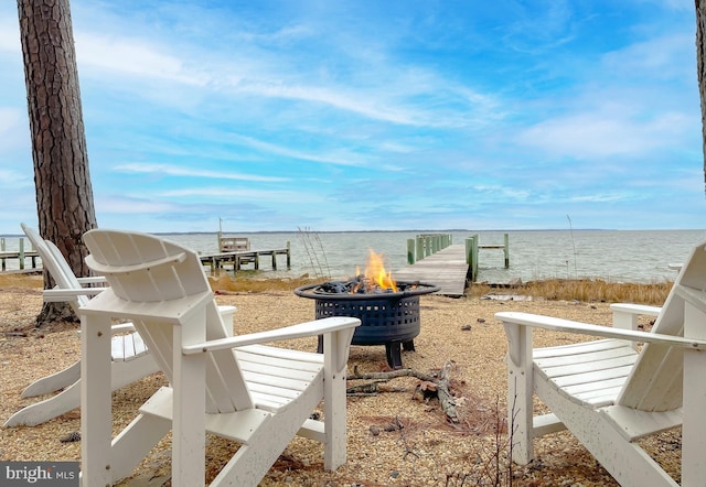 view of yard featuring a fire pit and a water view