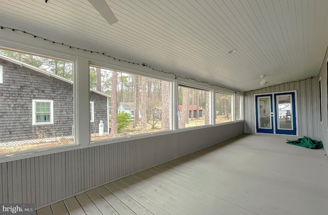 unfurnished sunroom with ceiling fan