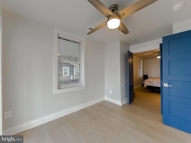 unfurnished bedroom with light wood finished floors, visible vents, baseboards, and ceiling fan