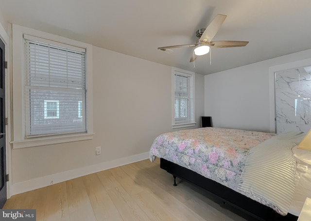 bedroom with ceiling fan, baseboards, and wood finished floors