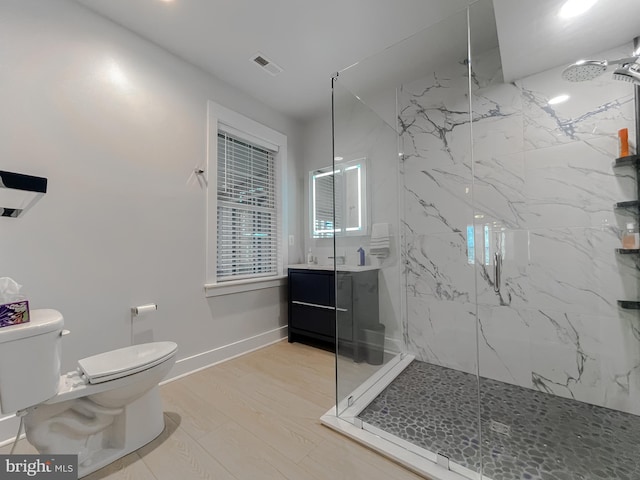 full bath with toilet, a marble finish shower, baseboards, and vanity