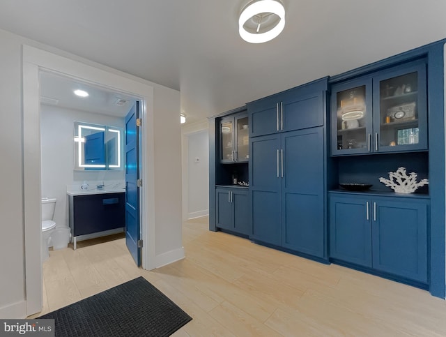 bar featuring visible vents, light wood-style flooring, and baseboards