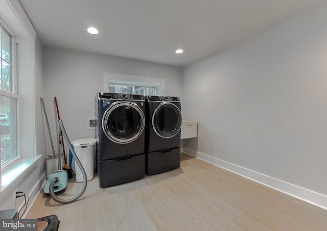 laundry area featuring recessed lighting, separate washer and dryer, wood finished floors, laundry area, and baseboards