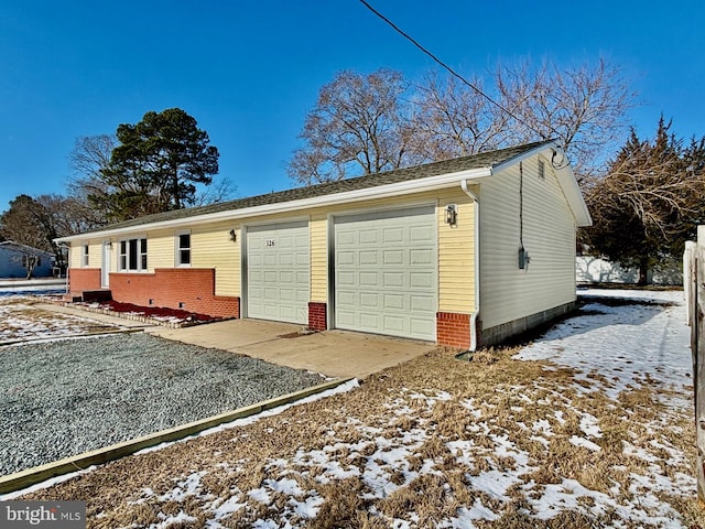 exterior space featuring brick siding and driveway