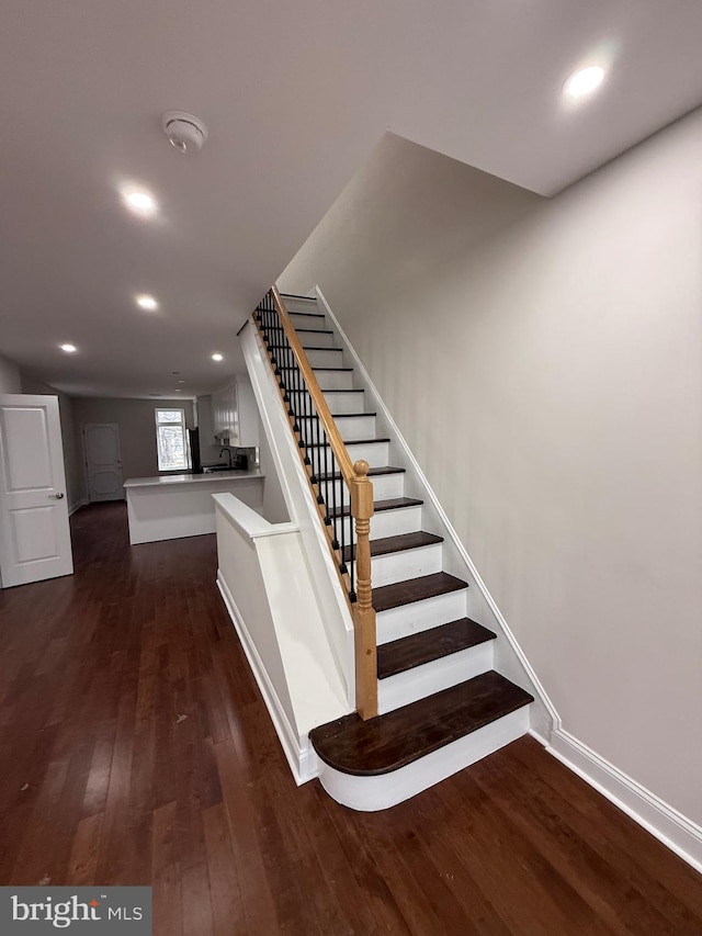 stairs featuring recessed lighting, baseboards, and wood finished floors