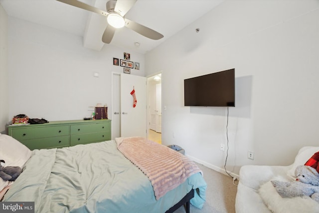 bedroom with ceiling fan, baseboards, and light colored carpet