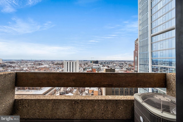 balcony with a view of city and central AC unit