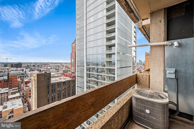 balcony with central AC unit and a city view