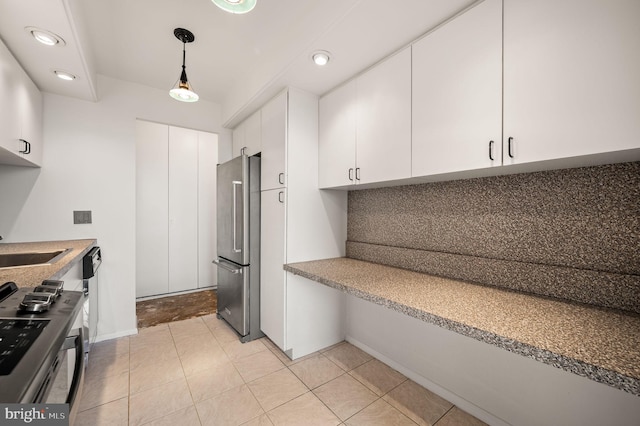 kitchen with tasteful backsplash, hanging light fixtures, stainless steel appliances, white cabinetry, and a sink