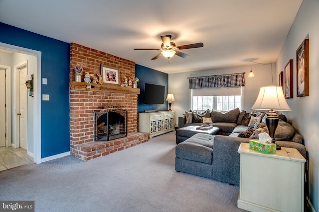 living room featuring ceiling fan, carpet floors, a brick fireplace, and baseboards