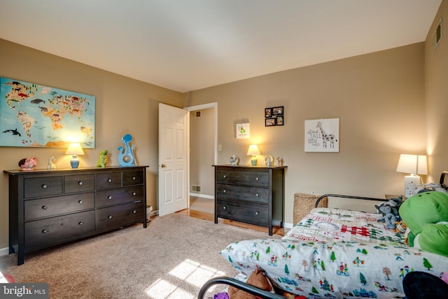 bedroom with baseboards and light colored carpet