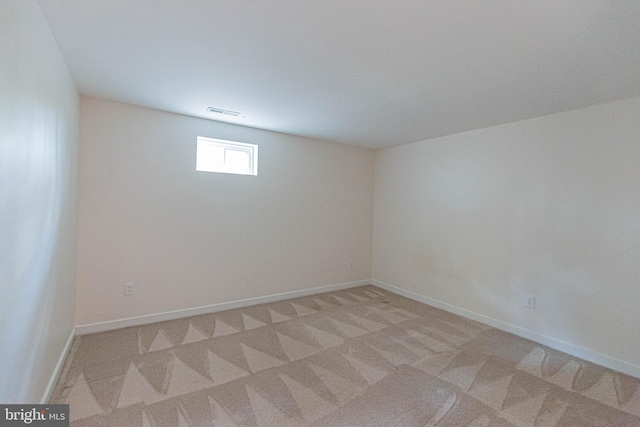 unfurnished room with baseboards, light carpet, and visible vents