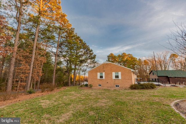 view of side of property with a yard