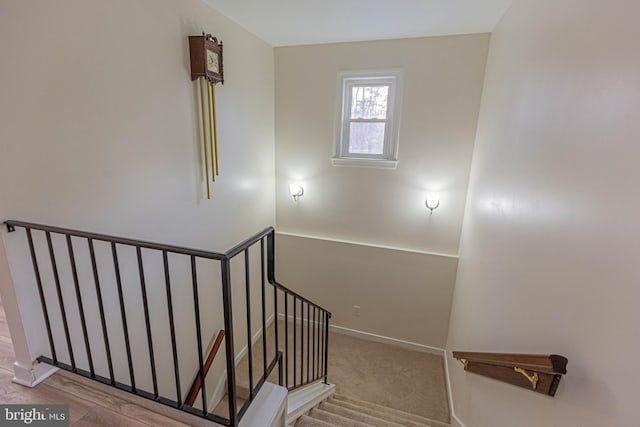 stairway featuring carpet flooring and baseboards