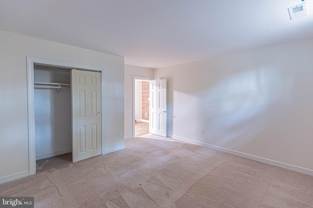 unfurnished bedroom with visible vents, baseboards, carpet, and a closet