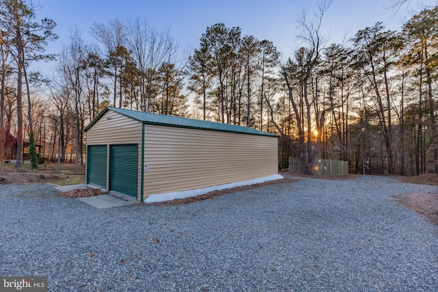 view of garage at dusk