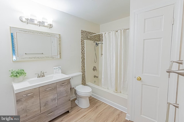 full bathroom featuring vanity, wood finished floors, toilet, and shower / bathtub combination with curtain