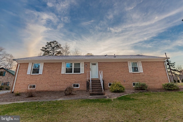 view of front of property with brick siding and a front yard