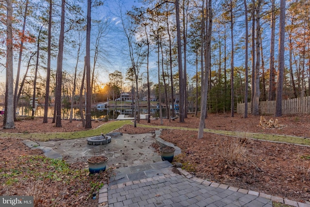 view of yard with a patio area, a fire pit, and fence