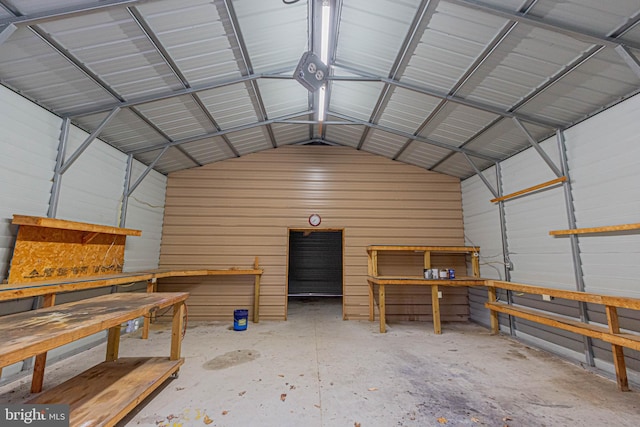 garage featuring a workshop area and metal wall