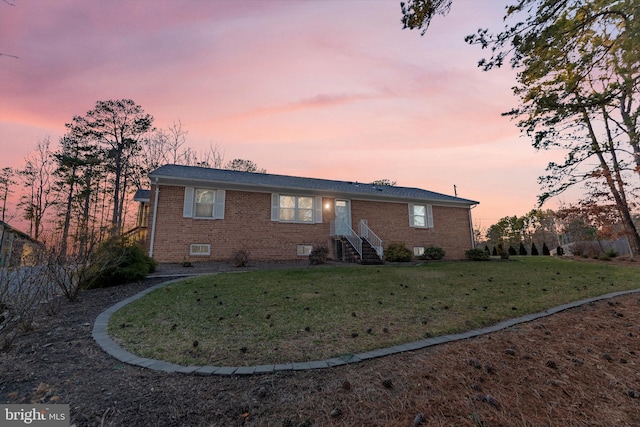 view of front of home featuring a front yard and brick siding